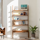 Born in Colour wooden shelf with multiple levels holding books, decorative items, and plants in a sunlit room